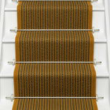 Striped flatweave runner in mustard black and ivory on white staircase