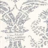 Detail of fabric in a mottled damask print in gray on a cream field.