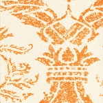 Detail of fabric in a mottled damask print in orange on a cream field.