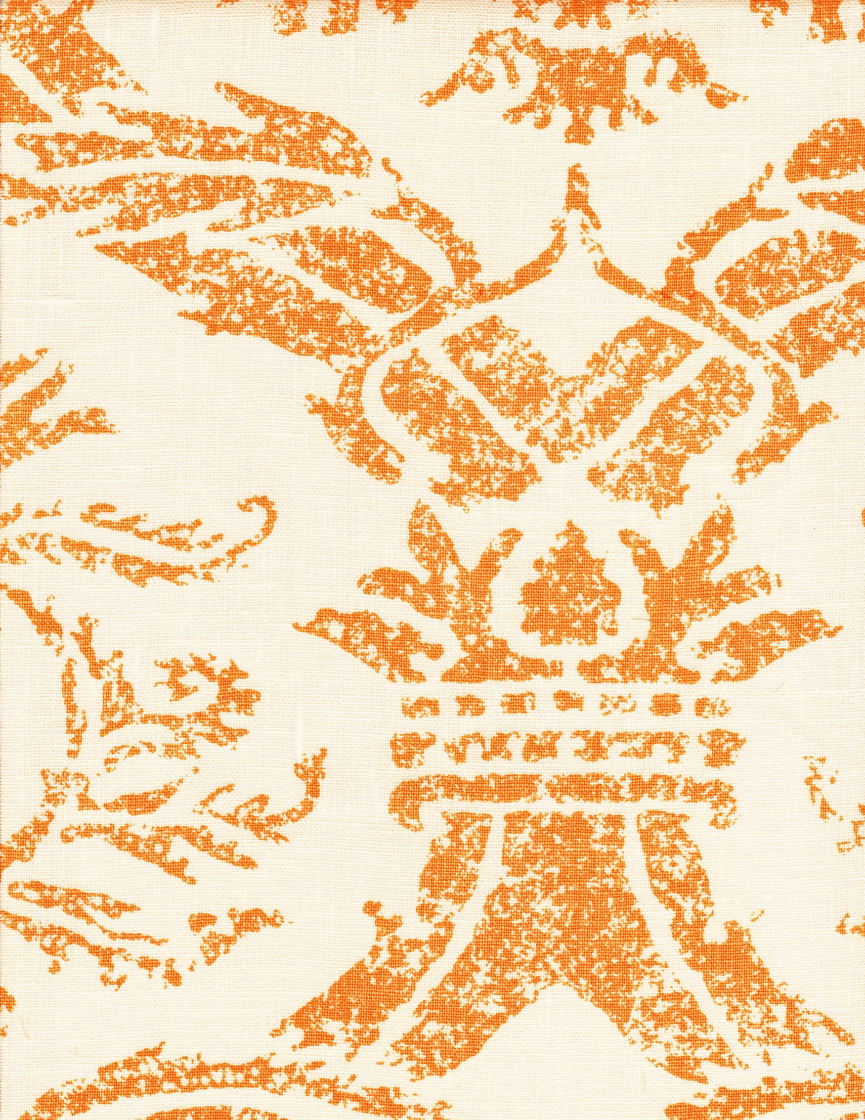 Detail of fabric in a mottled damask print in orange on a cream field.