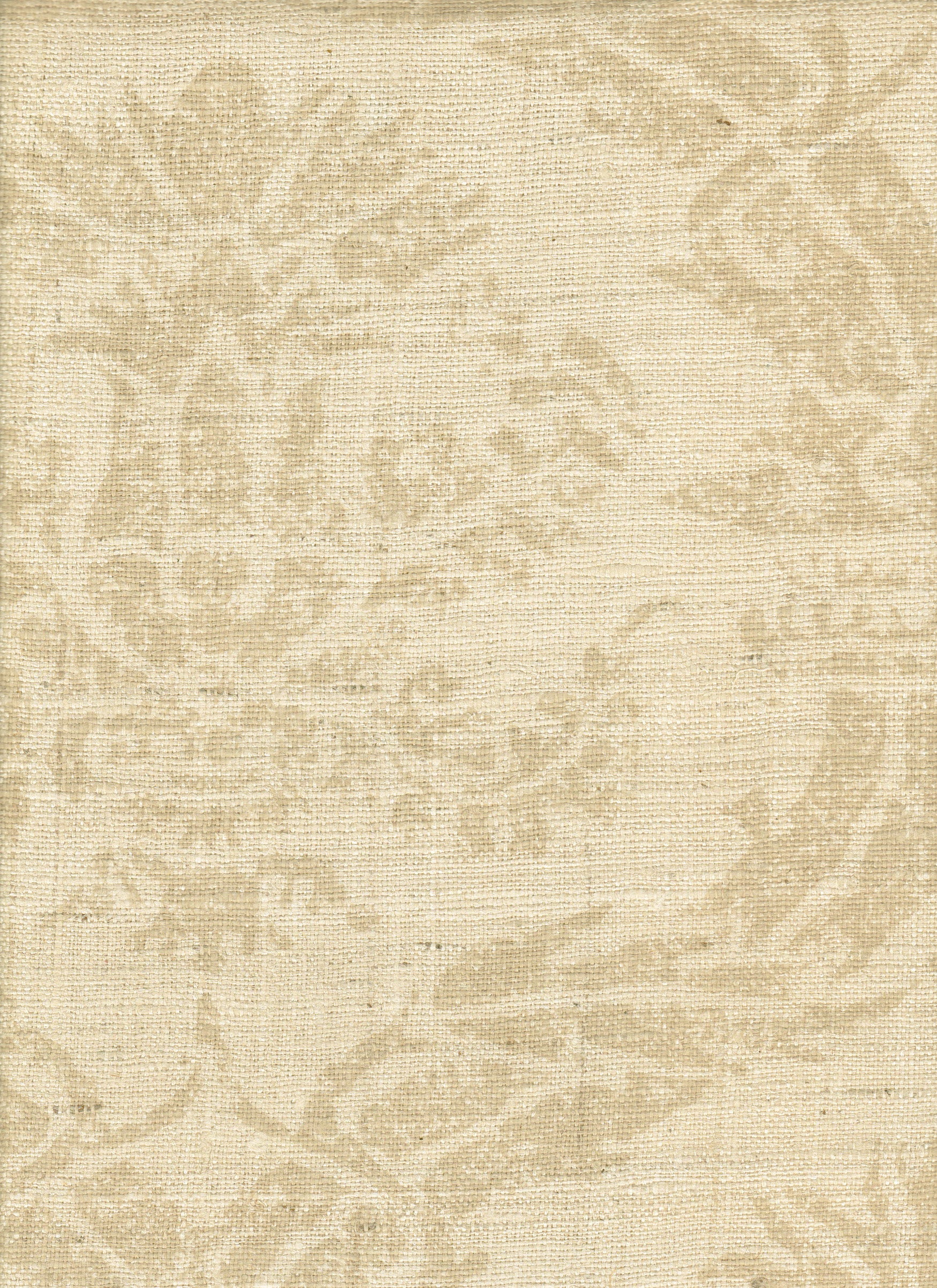 Detail of fabric in a mottled damask print in tan on a cream field.