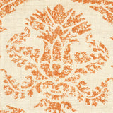 Detail of fabric in a mottled damask print in orange on a cream field.