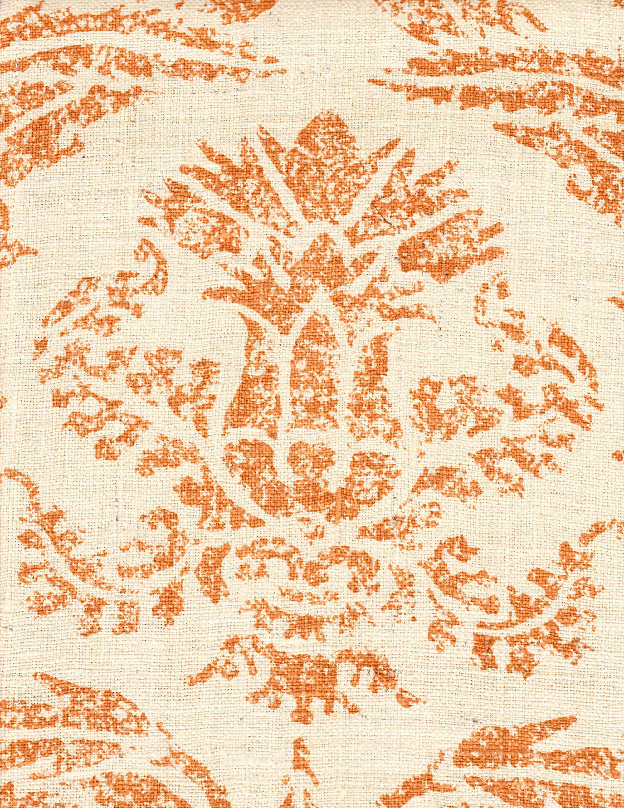 Detail of fabric in a mottled damask print in orange on a cream field.