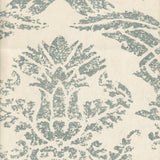 Detail of wallpaper in a mottled damask print in blue-gray on a cream field.