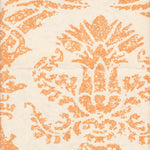 Detail of wallpaper in a mottled damask print in orange on a cream field.