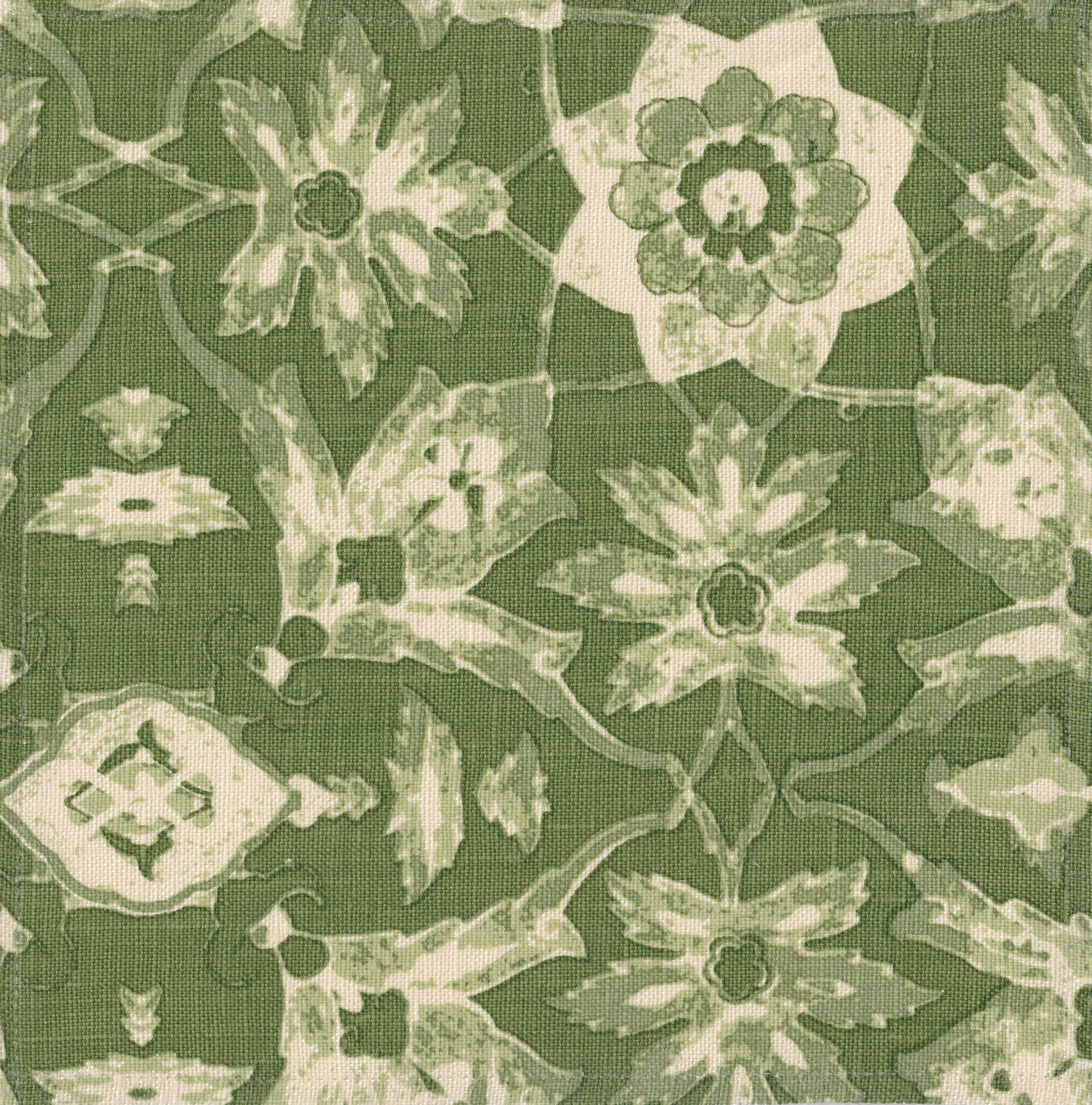 Detail of fabric in a floral damask print in shades of green and cream on a green field.