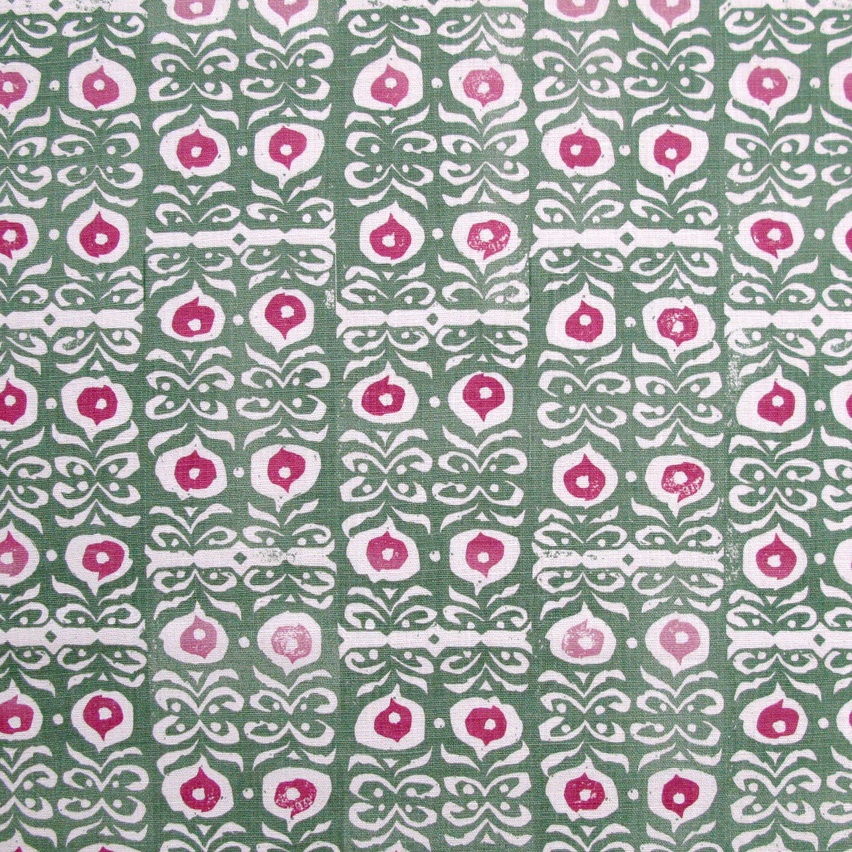 Fabric in a repeating damask print in white and pink on a green field.