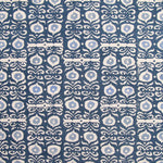 Fabric in a repeating damask print in white and blue on a navy field.