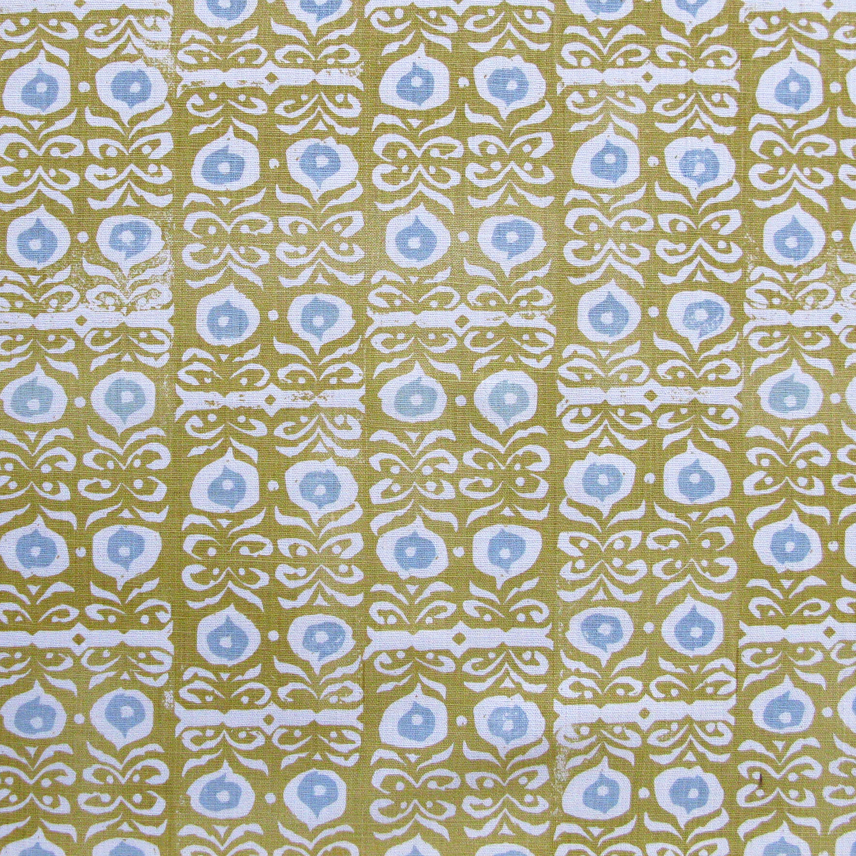 Fabric in a repeating damask print in white and blue on a mustard field.