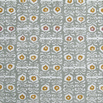 Fabric in a repeating damask print in white and gold on a blue-gray field.