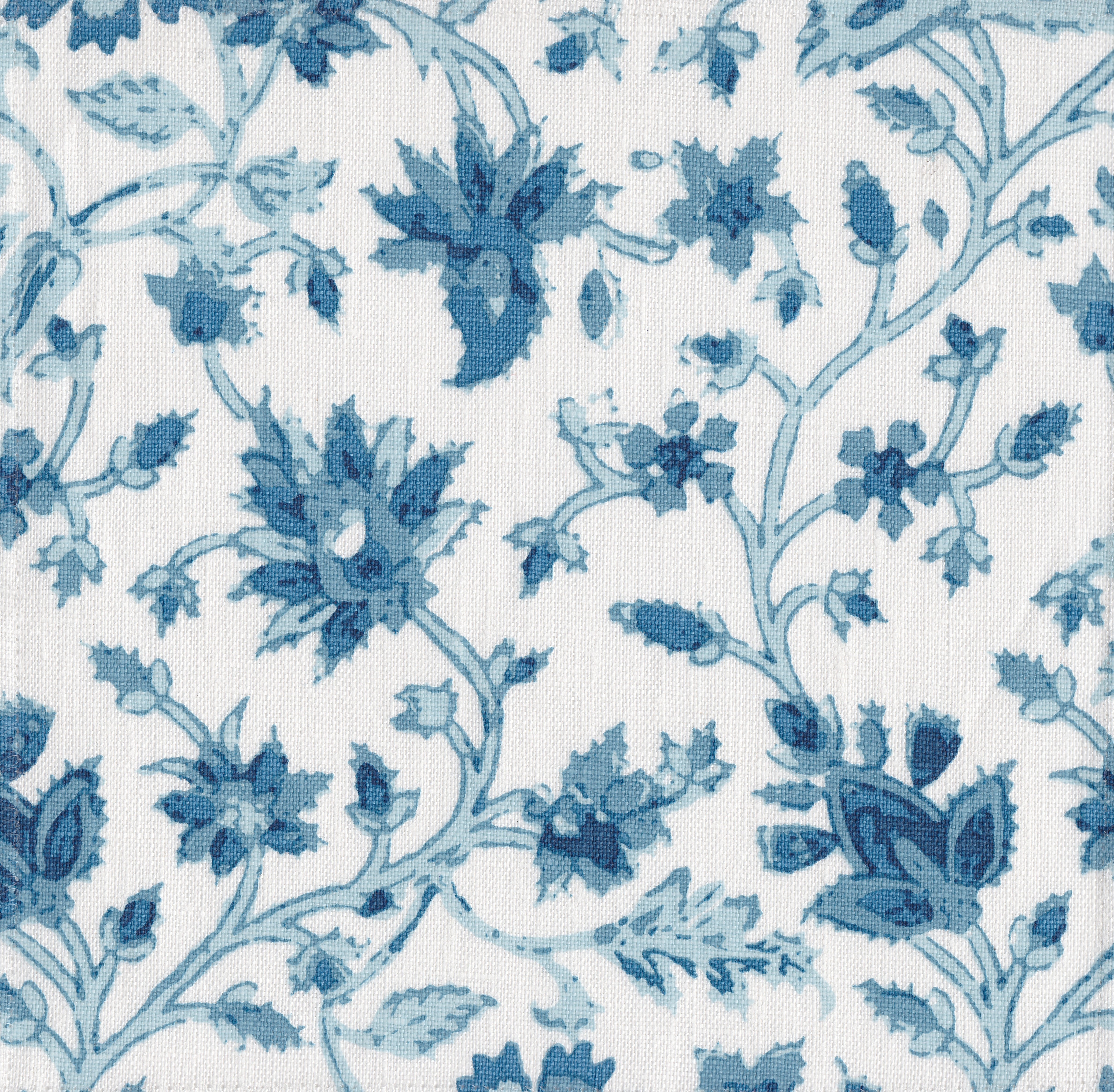 Detail of fabric in a floral damask print in shades of blue and navy on a white field.