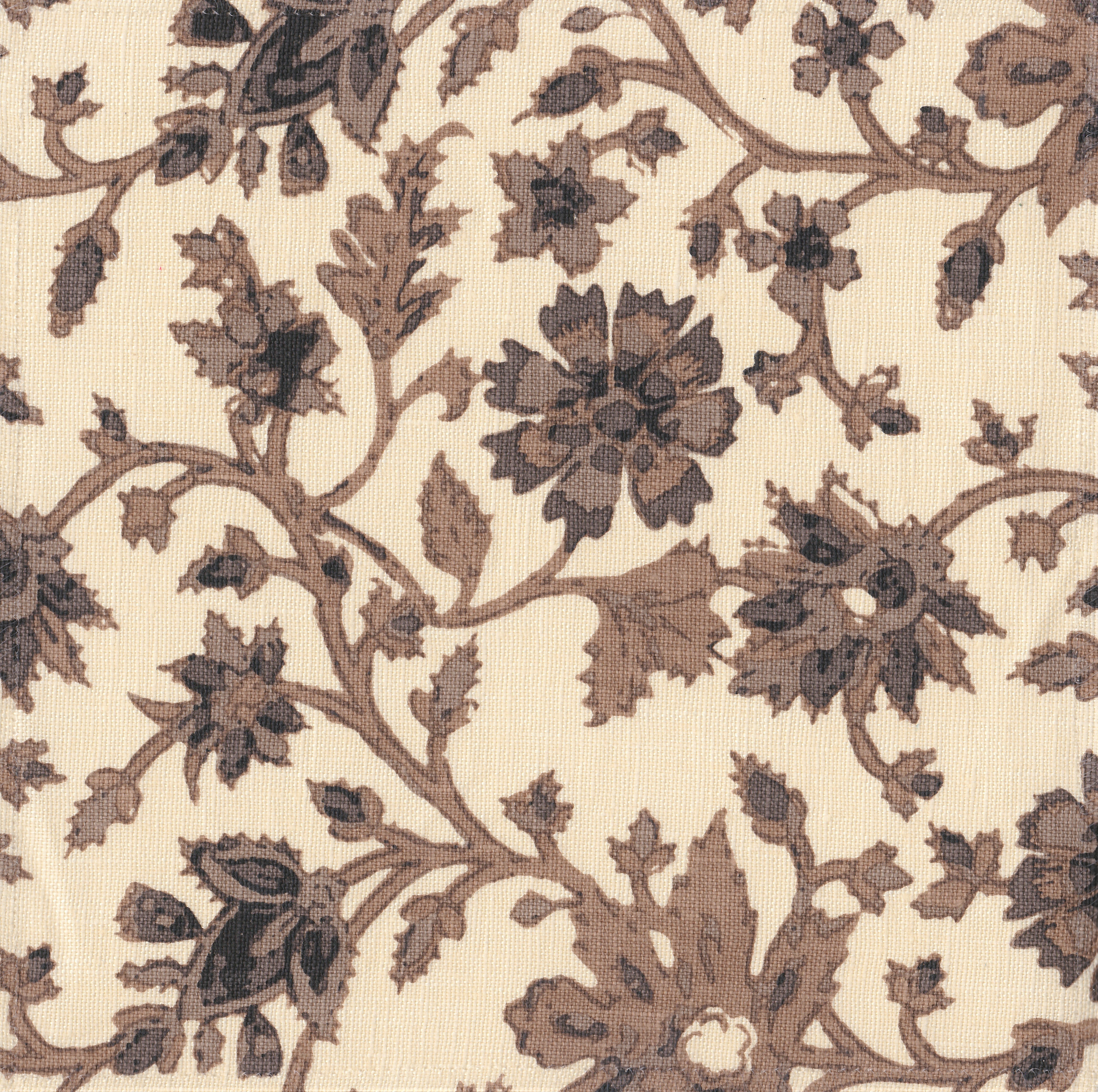 Detail of fabric in a floral damask print in shades of brown and gray on a cream field.