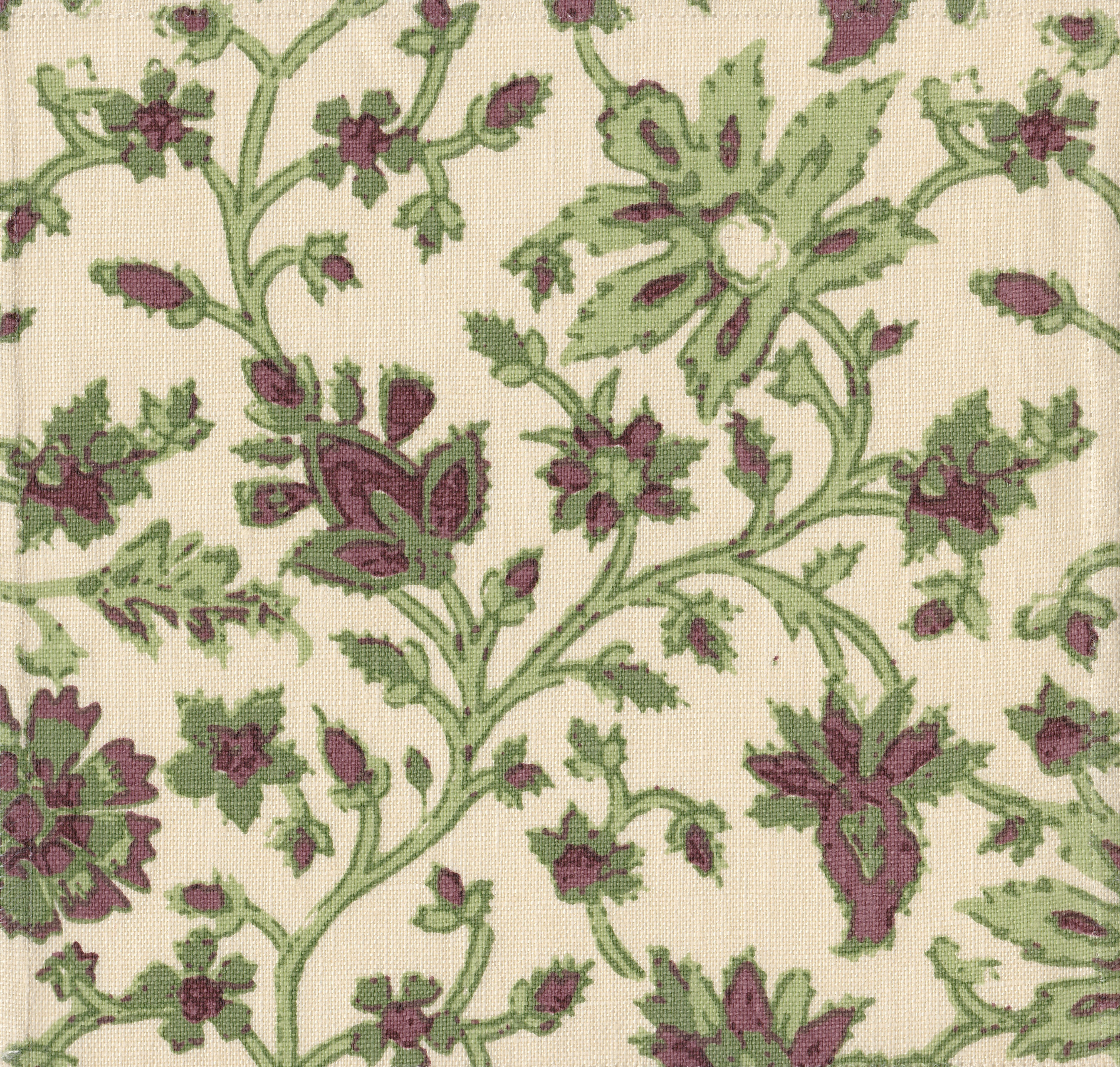 Detail of fabric in a floral damask print in shades of green and purple on a cream field.