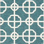 Detail of fabric in a geometric lattice print in white on a dark turquoise field.