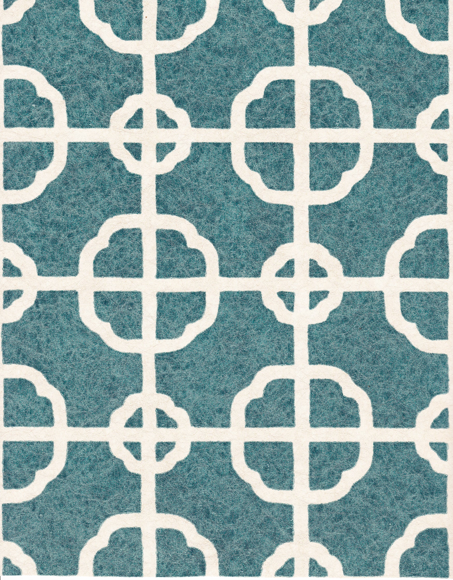 Detail of fabric in a geometric lattice print in white on a dark turquoise field.