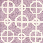 Detail of fabric in a geometric lattice print in white on a purple field.