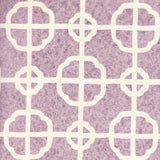 Detail of fabric in a geometric lattice print in white on a purple field.