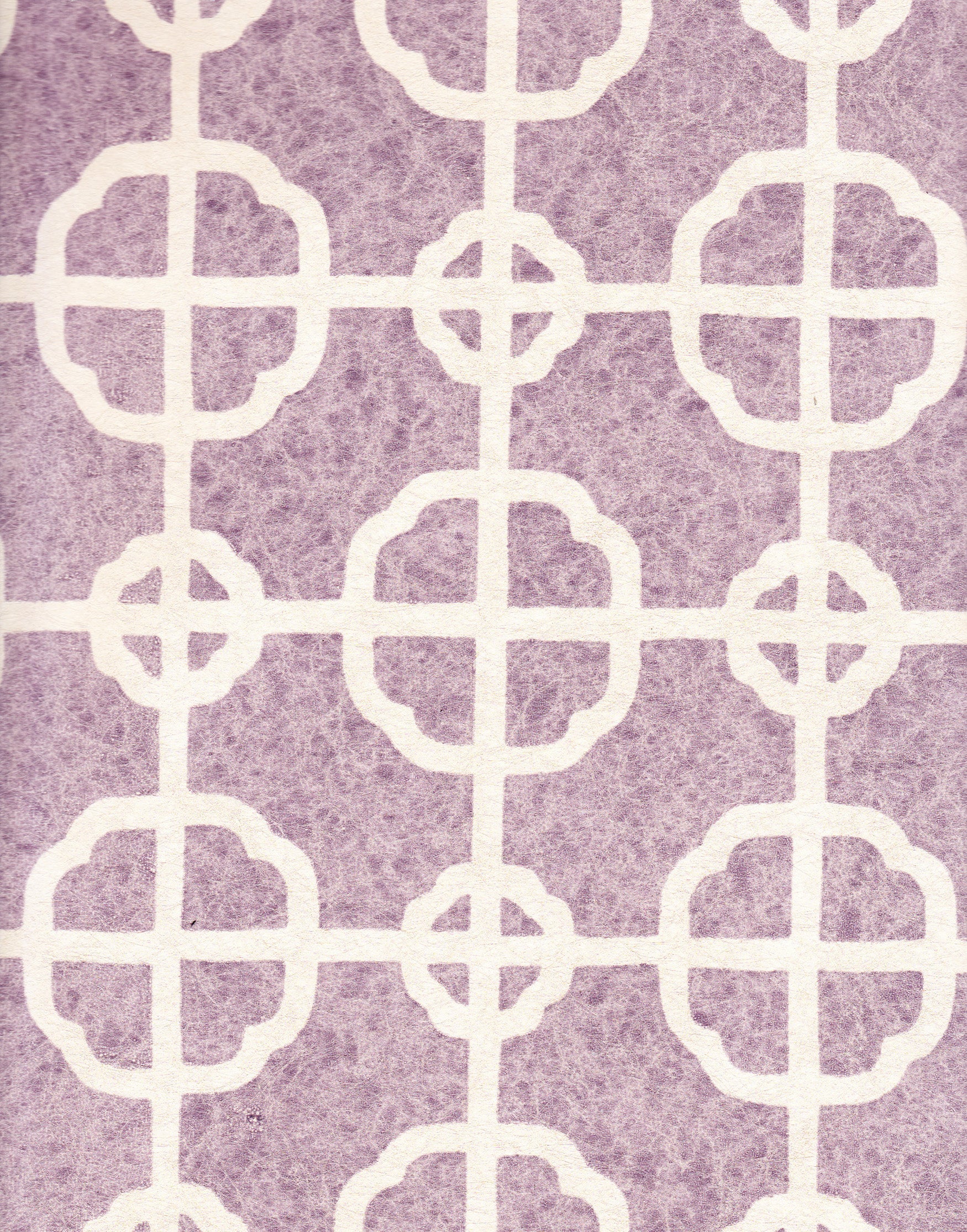 Detail of fabric in a geometric lattice print in white on a purple field.