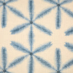 Detail of fabric in a global geometric print in indigo on a cream field.