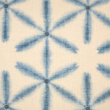 Detail of fabric in a global geometric print in indigo on a cream field.