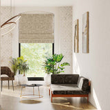 A minimalist living space with a couch and curtains upholstered in a geometric pattern in black and gray.