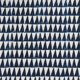 Detail of fabric in a repeating triangle print in navy on a white field.