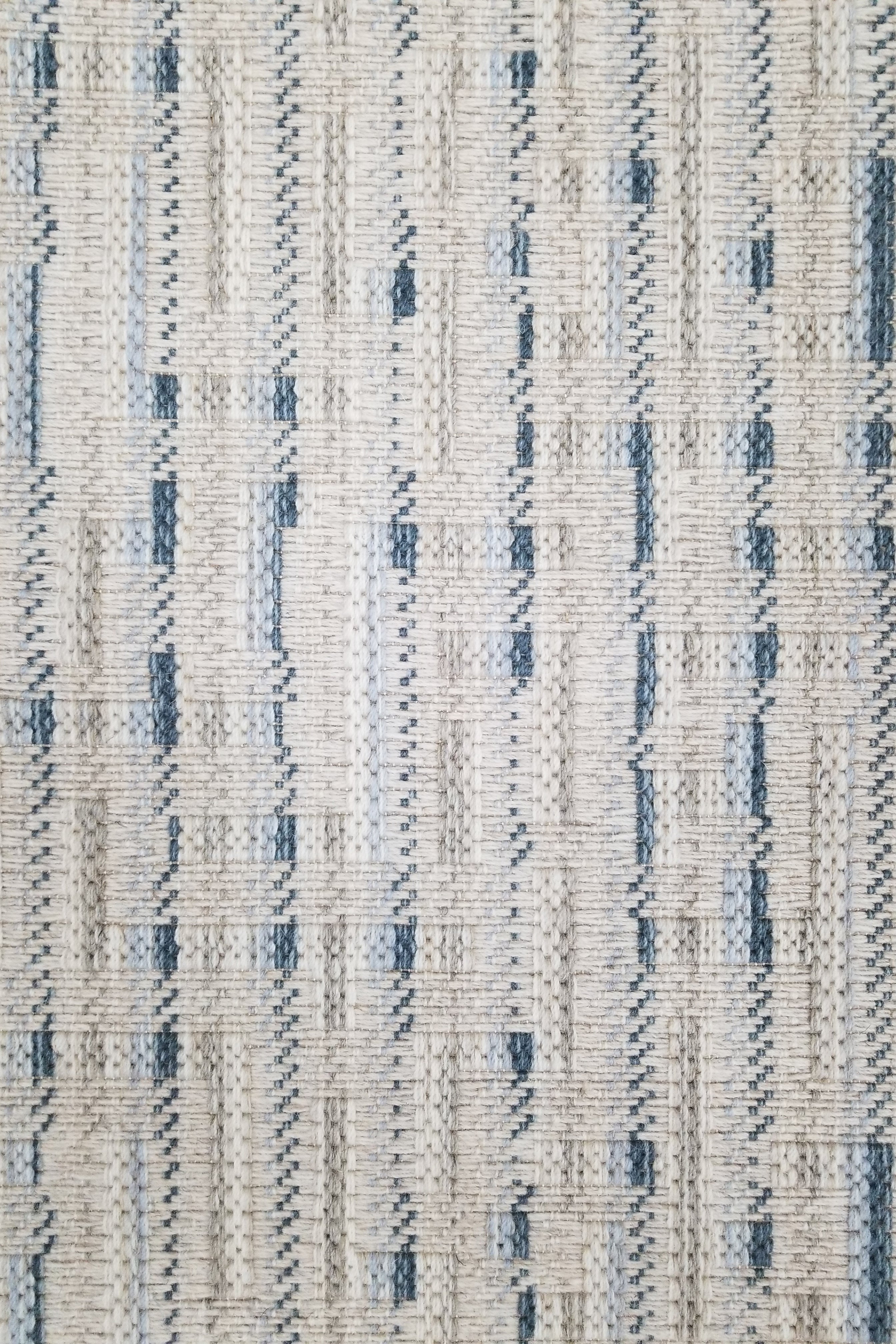 Textured broadloom carpet with blue and beige stripes