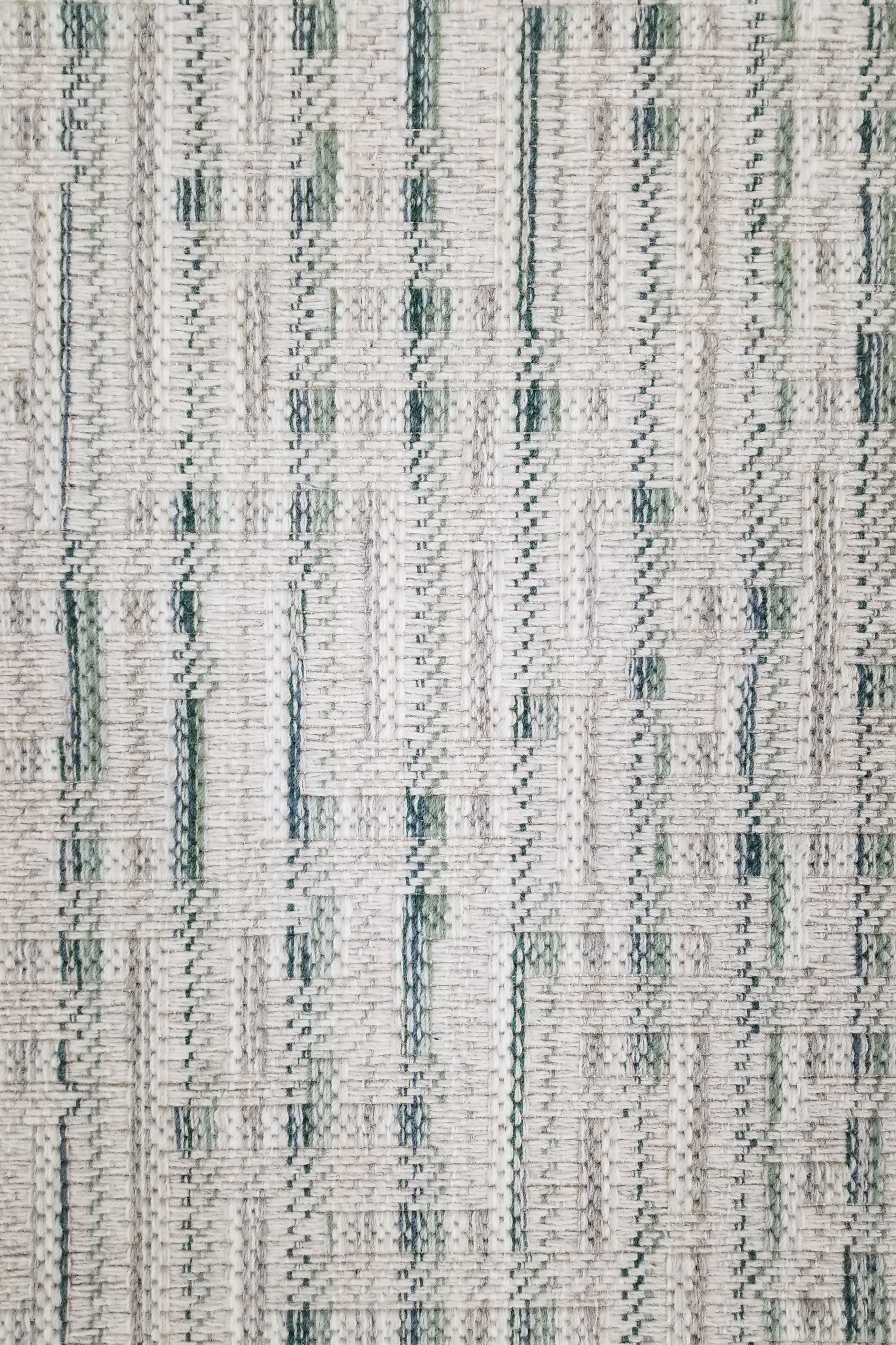 Textured broadloom carpet with green and grey stripes