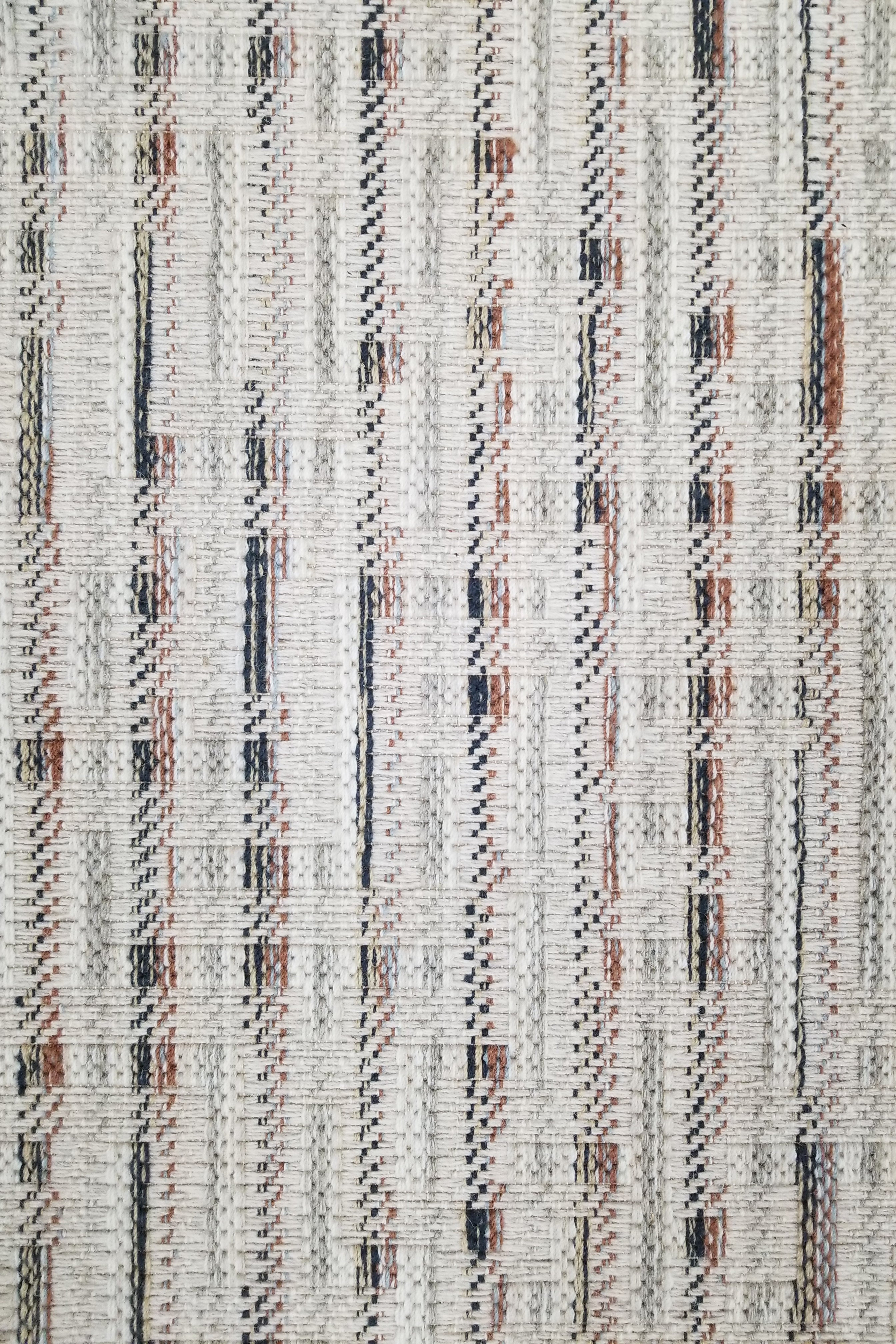 Textured broadloom with vertical stripes in orange and navy.