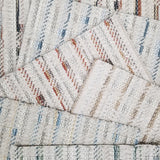 Broadloom carpet samples with textural stripes on a cream ground in a range of colors. 