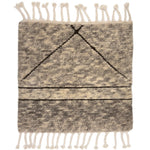 Textured rug  sample with geometric pattern and tassels on a plain background