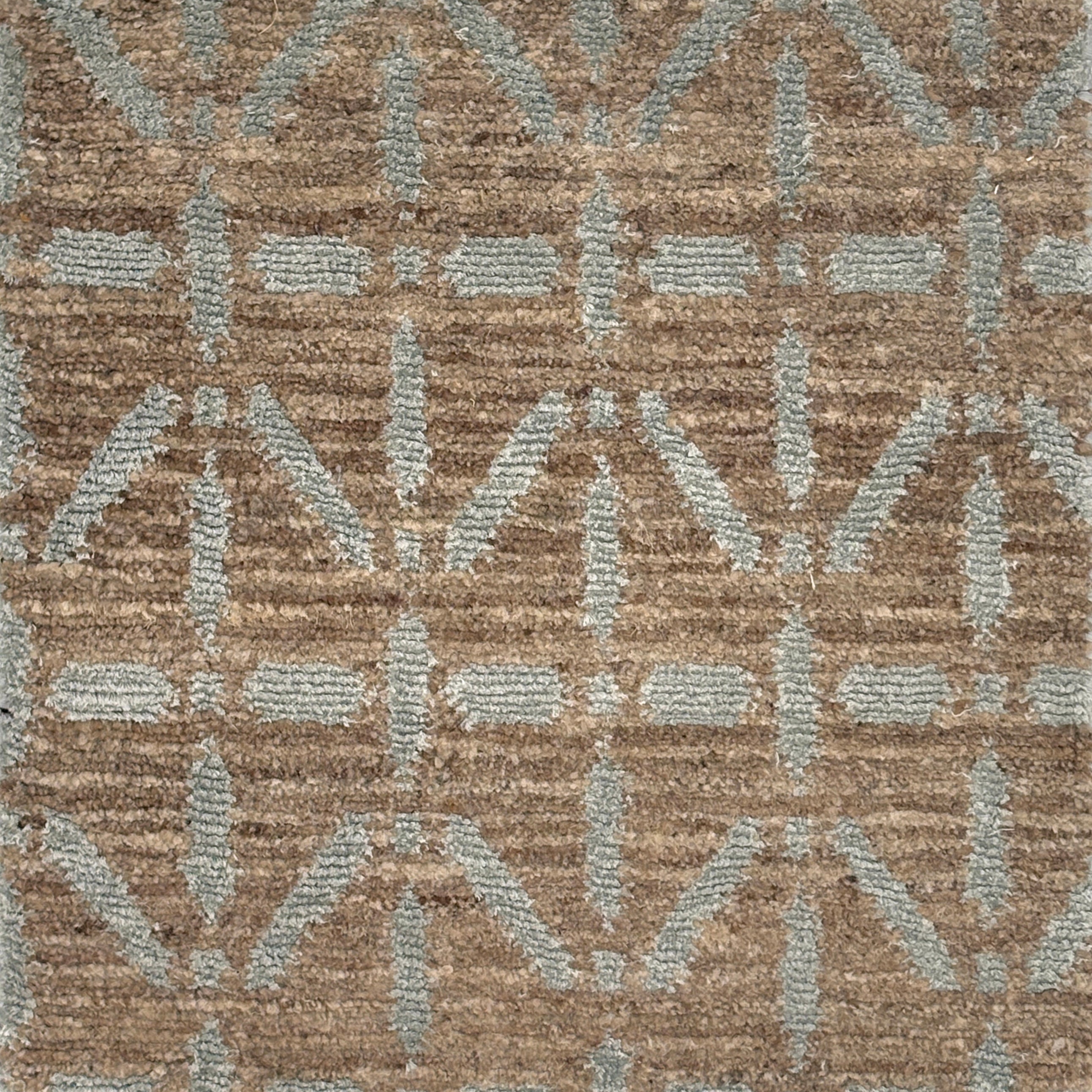 Handknotted rug with grey linear design on a heather brown field. 