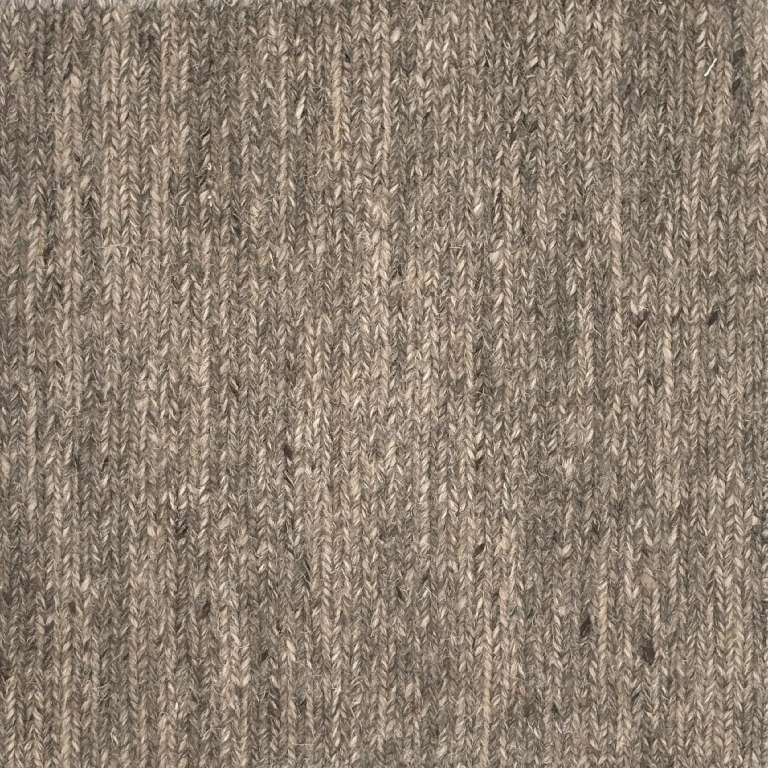 Close up of a carpet with a herringbone weave in heather grey.