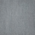 Close up of a carpet with a herringbone weave in light blue.