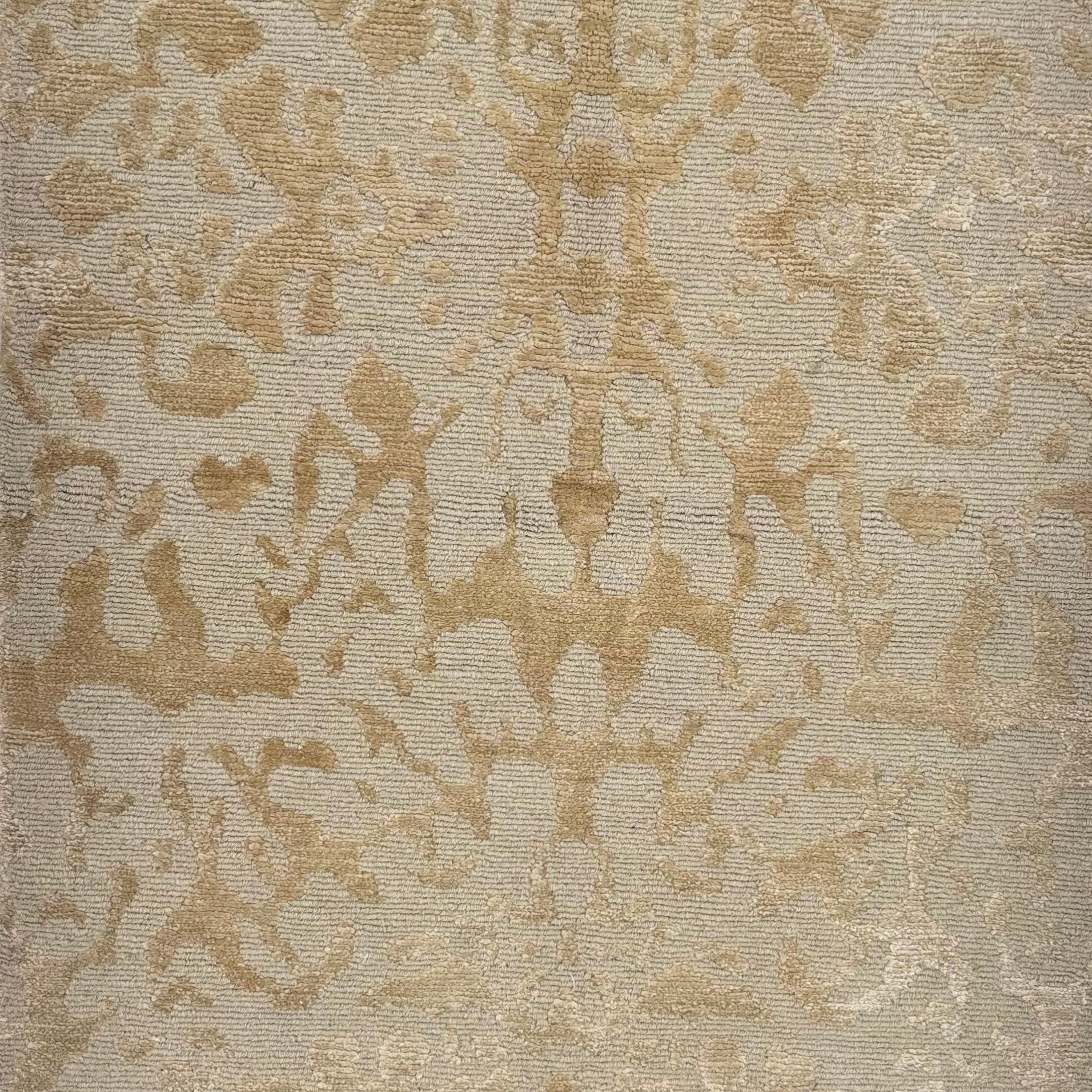 Handknotted rug sample in an organic abstract pattern in tan. 