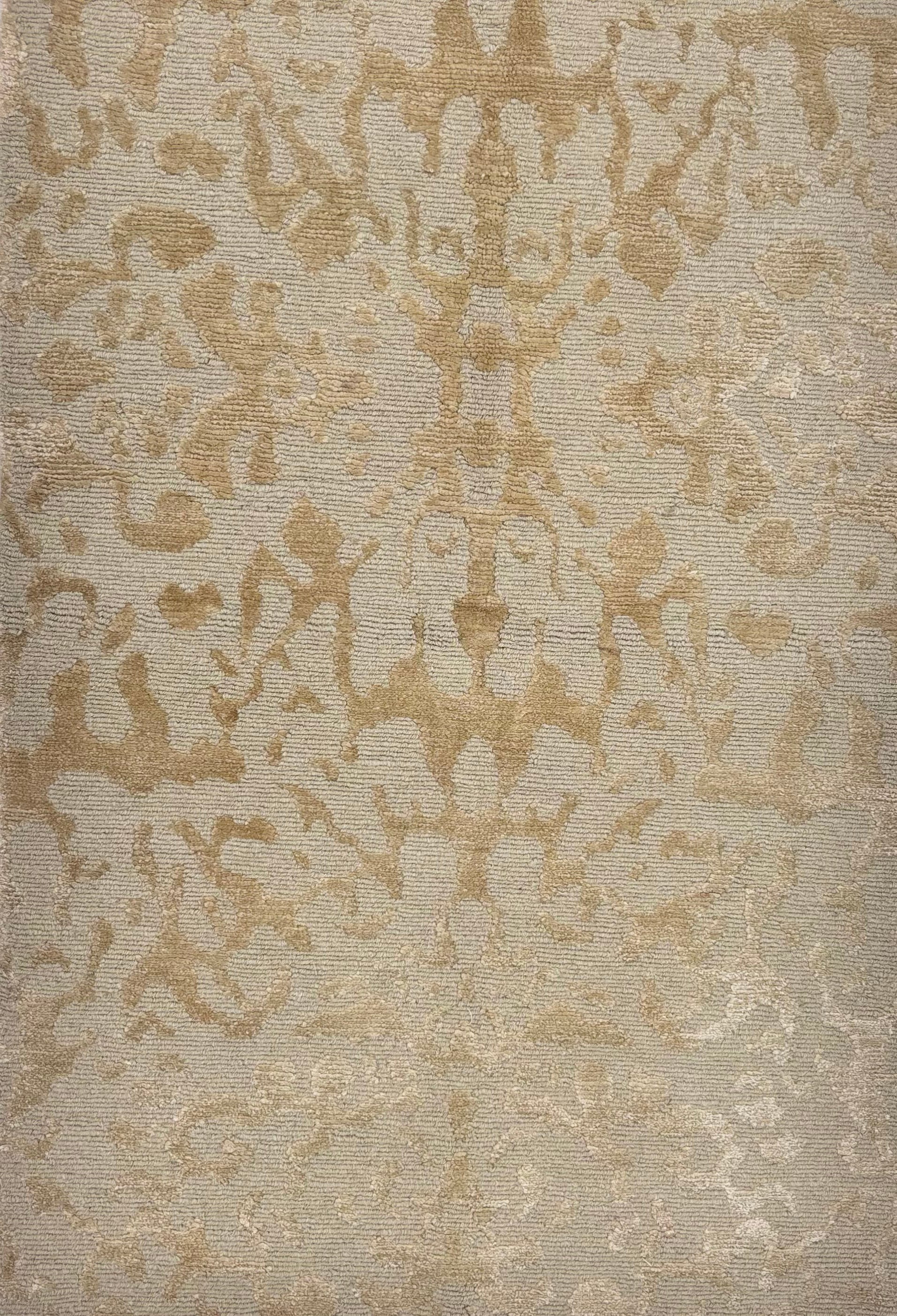 Handknotted rug sample in an organic abstract pattern in tan. 