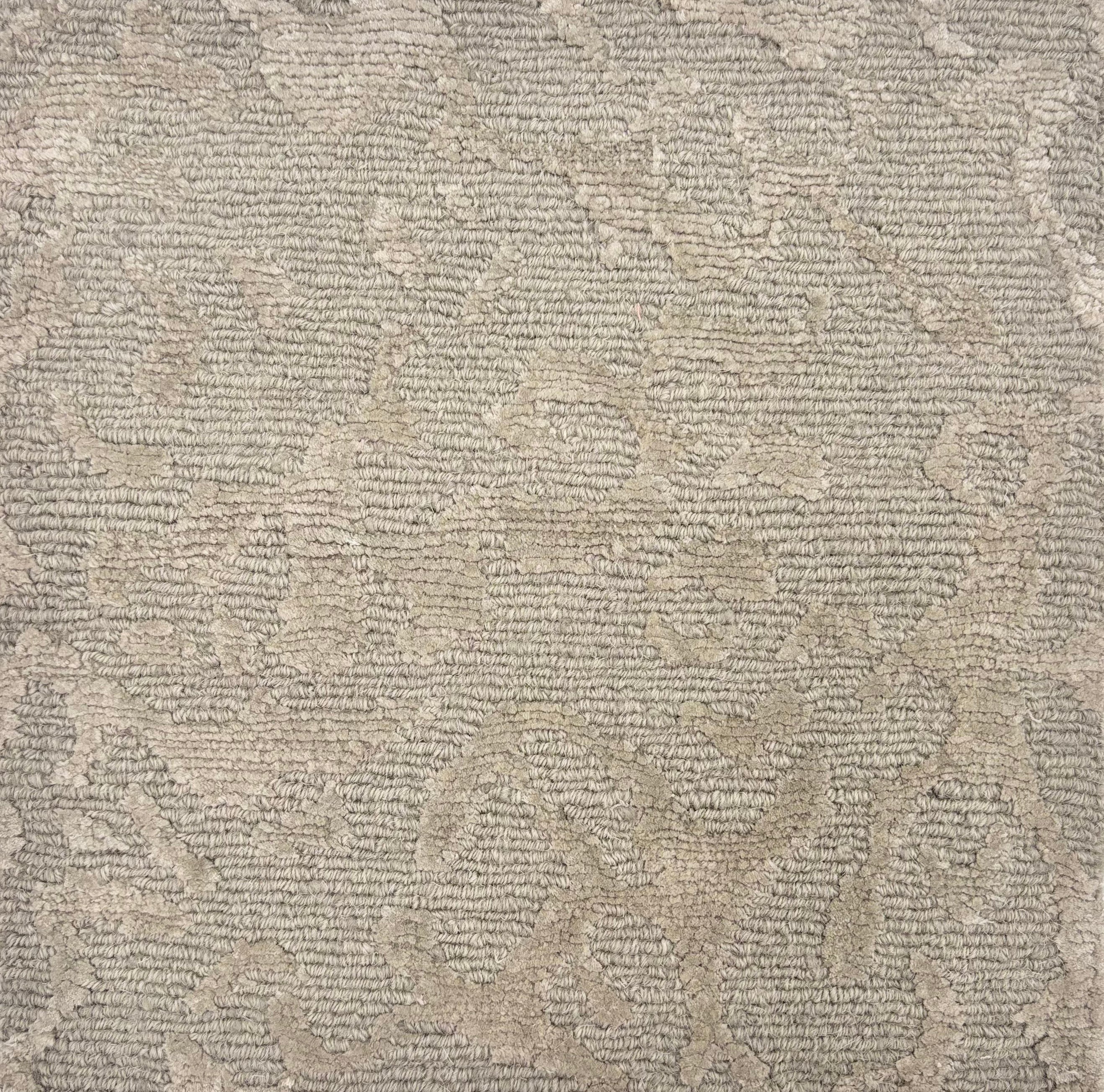 Handknotted rug sample in an organic abstract pattern in soft grey.