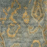 Handknotted rug in an abstract ikat design in tan on a blue-grey field