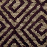 Close-up of a handknotted rug with a purple geometric pattern on a beige background