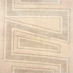 Handknotted rug sample in a large scale zig zag stripe in tonal shades of cream.