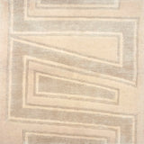 Handknotted rug sample in a large scale zig zag stripe in tonal shades of cream.