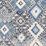 Detail of fabric in a painterly diamond print in shades of blue, tan and gray.