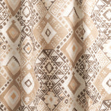 Draped fabric yardage in a painterly diamond print in shades of brown, tan and white.