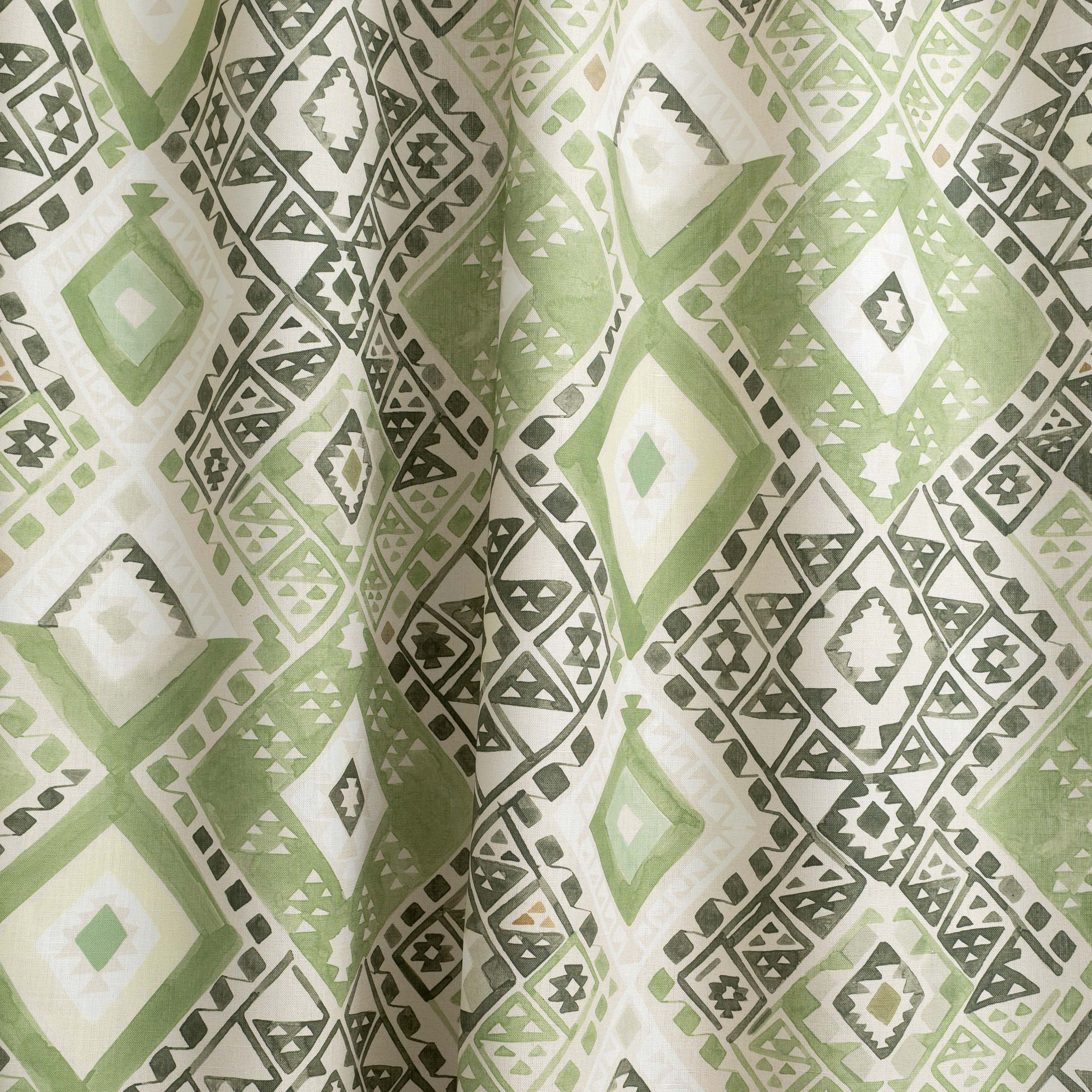 Draped fabric yardage in a painterly diamond print in shades of green, gray and white.