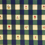 Checkered fabric pattern with floral accents in green, blue, and beige.