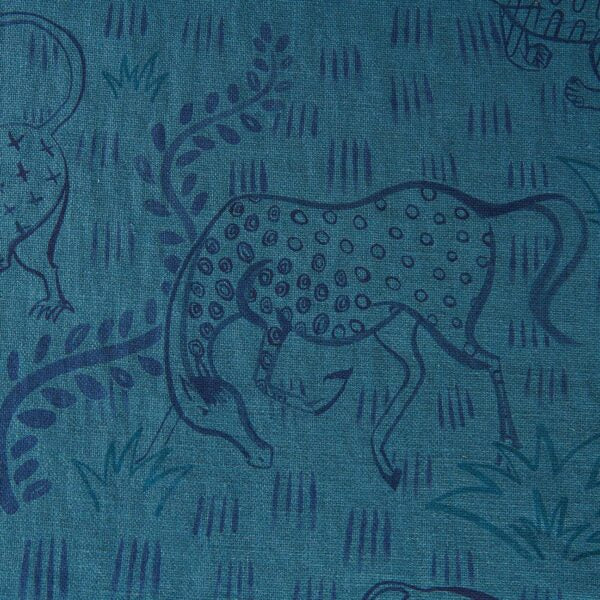 Fabric in a repeating painterly animal and dash print in navy on a blue field.