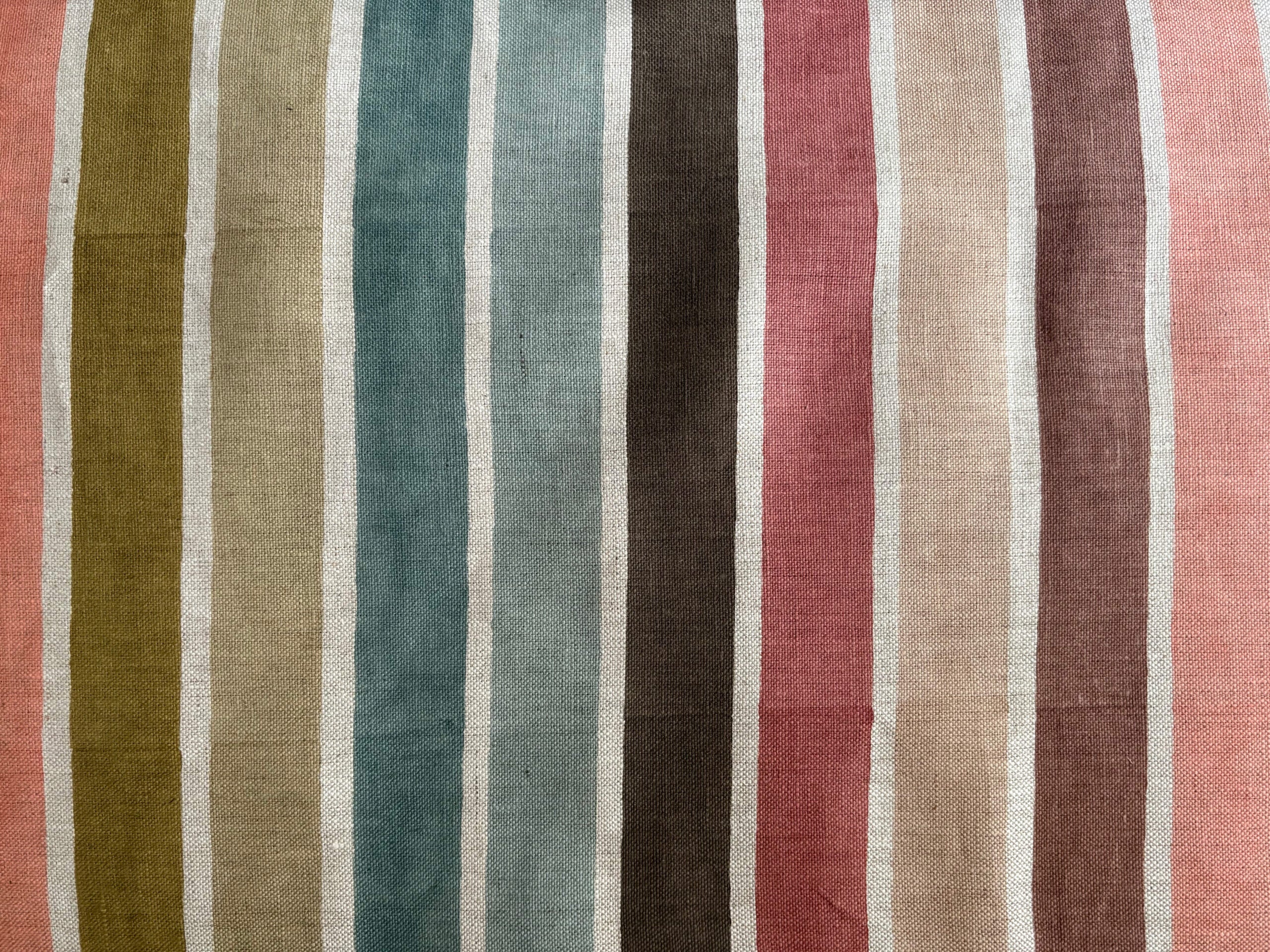 Striped fabric with a pattern of multicolored vertical stripes.