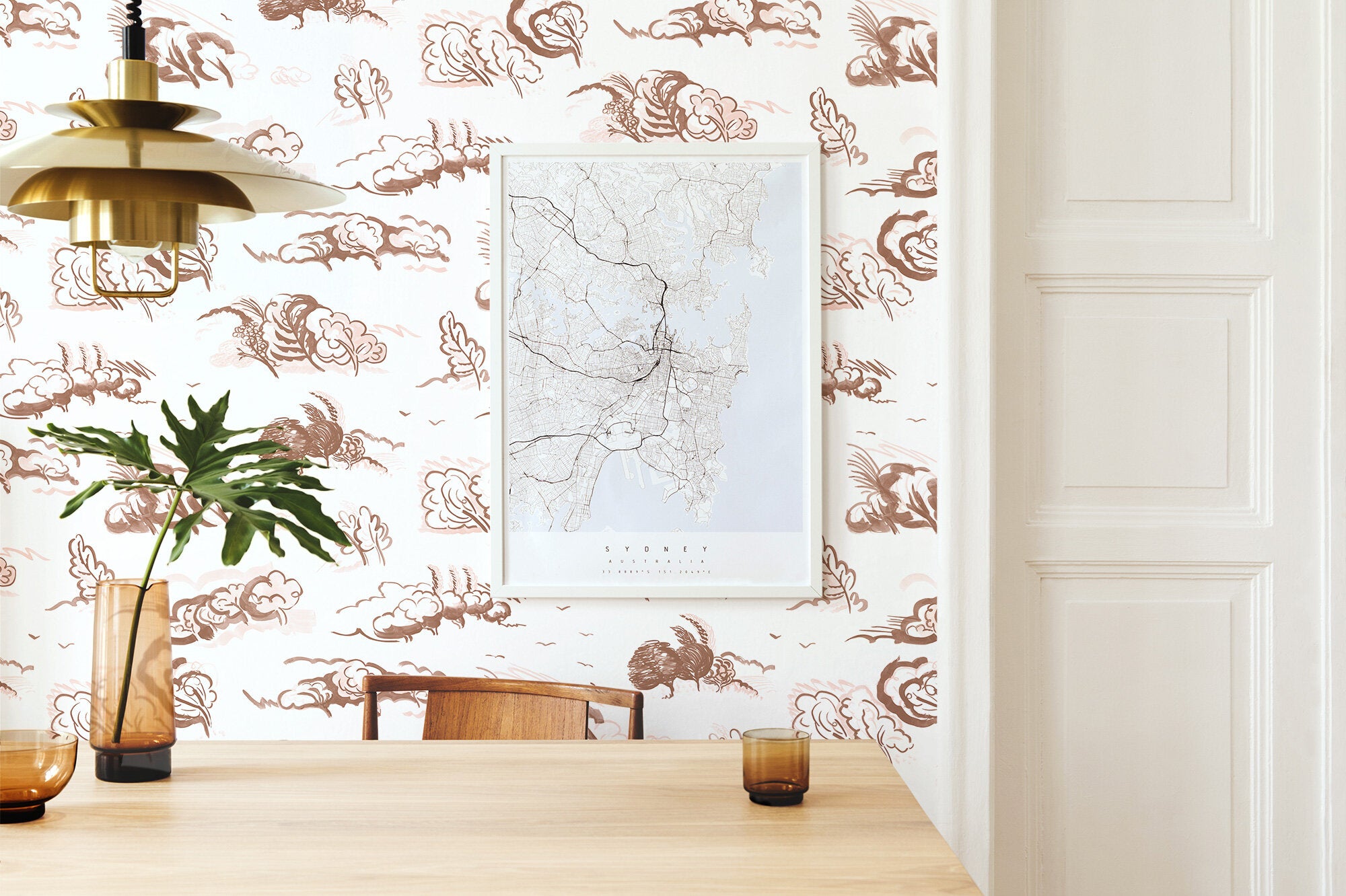 Modernist dining room with a wall papered in a painterly windswept tree print in shades of brown and cream on a white field.