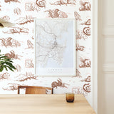 Modernist dining room with a wall papered in a painterly windswept tree print in shades of brown and cream on a white field.