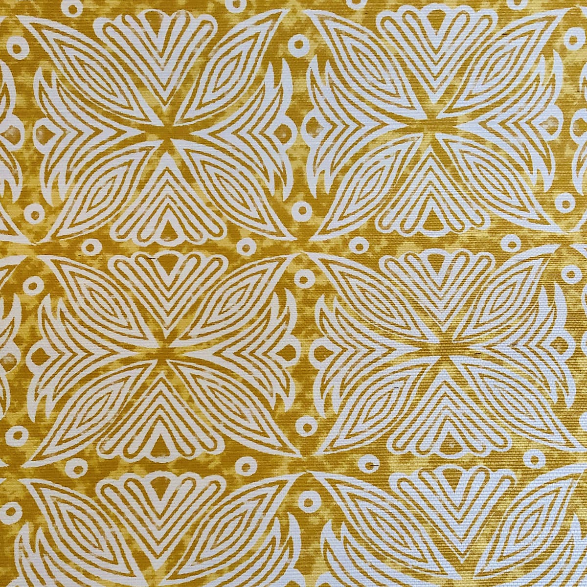 Detail of fabric in a botanical geometric print in shades of brown, yellow and white.